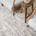 Beige and brown textured wool rug with natural speckled pattern