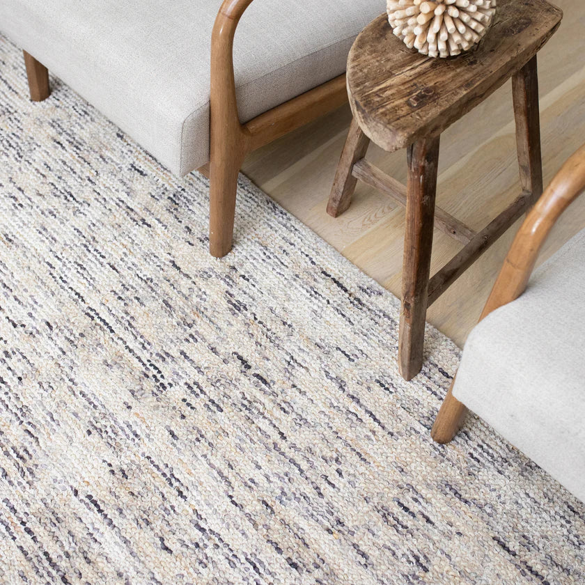 Beige and brown textured wool rug with natural speckled pattern