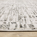 Modern geometric patterned rug in cream and brown tones on wood flooring