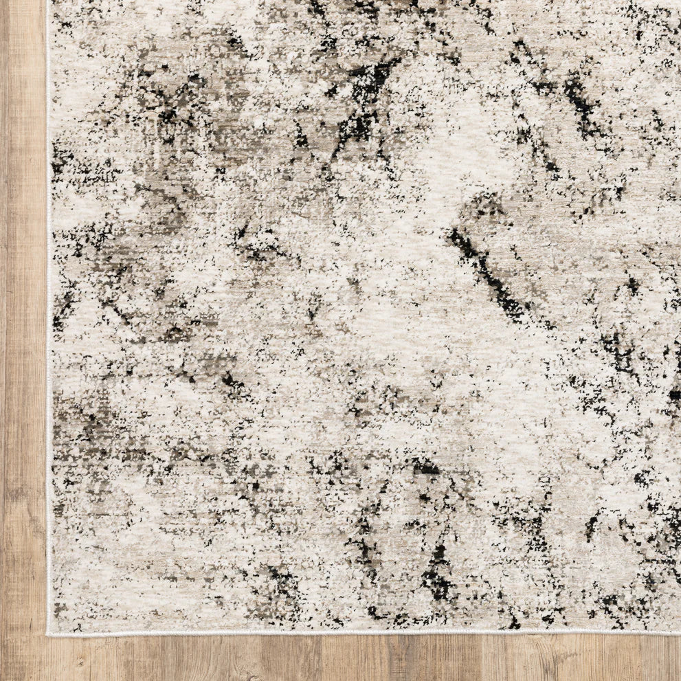 Modern distressed rug with black speckled pattern on cream background texture