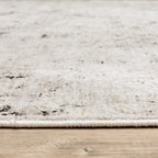 Modern distressed rug with black speckled pattern on cream background texture
