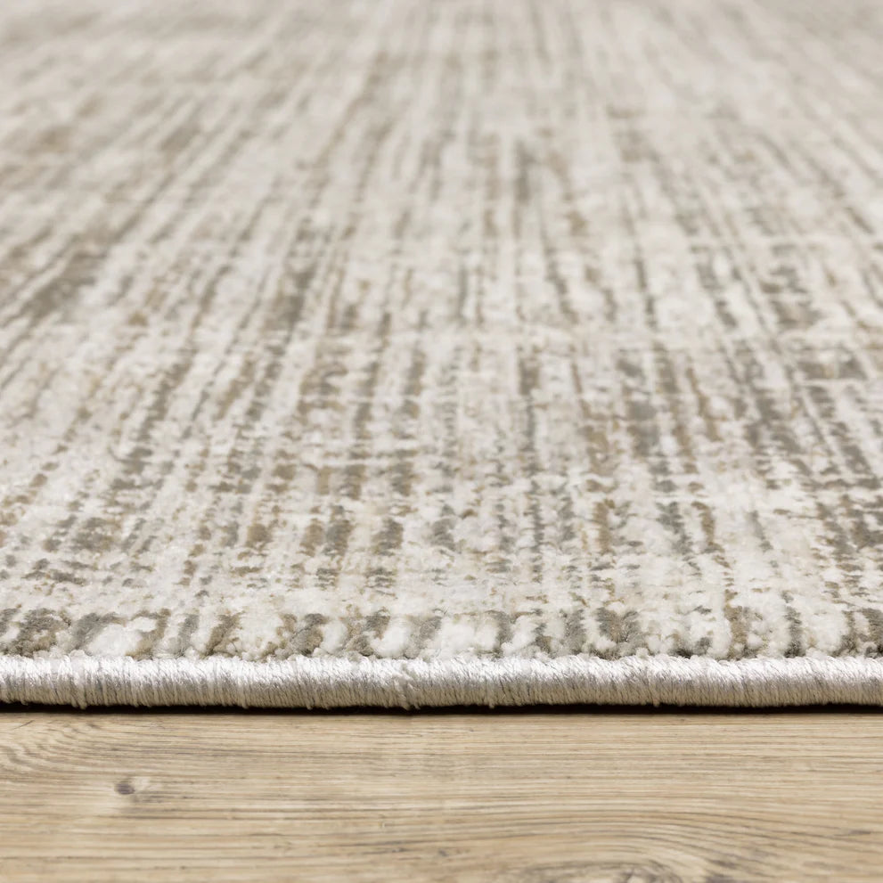 Beige textured area rug with abstract grid pattern on light wood flooring
