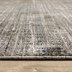 Gray textured area rug with white linear crosshatch pattern throughout