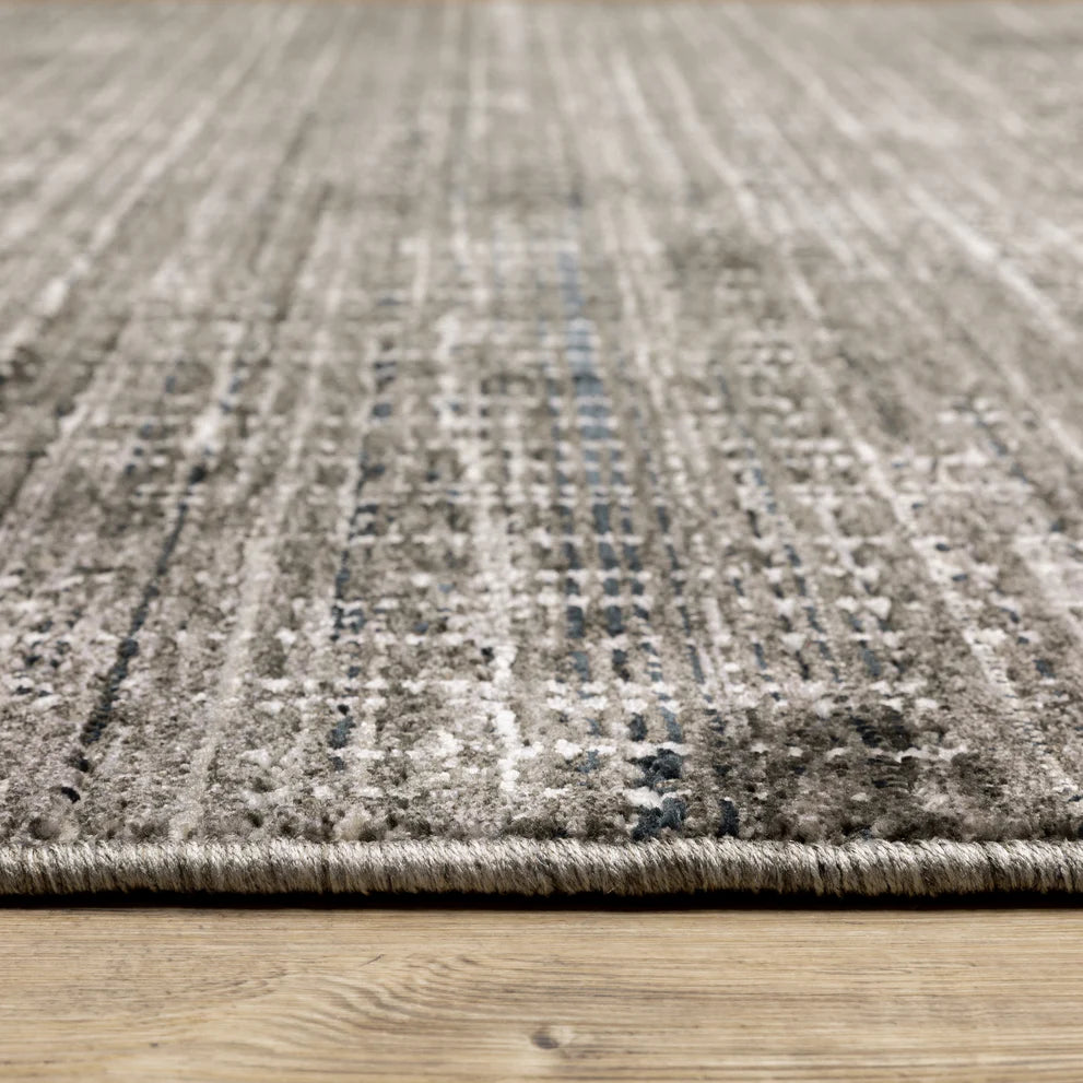 Gray textured area rug with white linear crosshatch pattern throughout