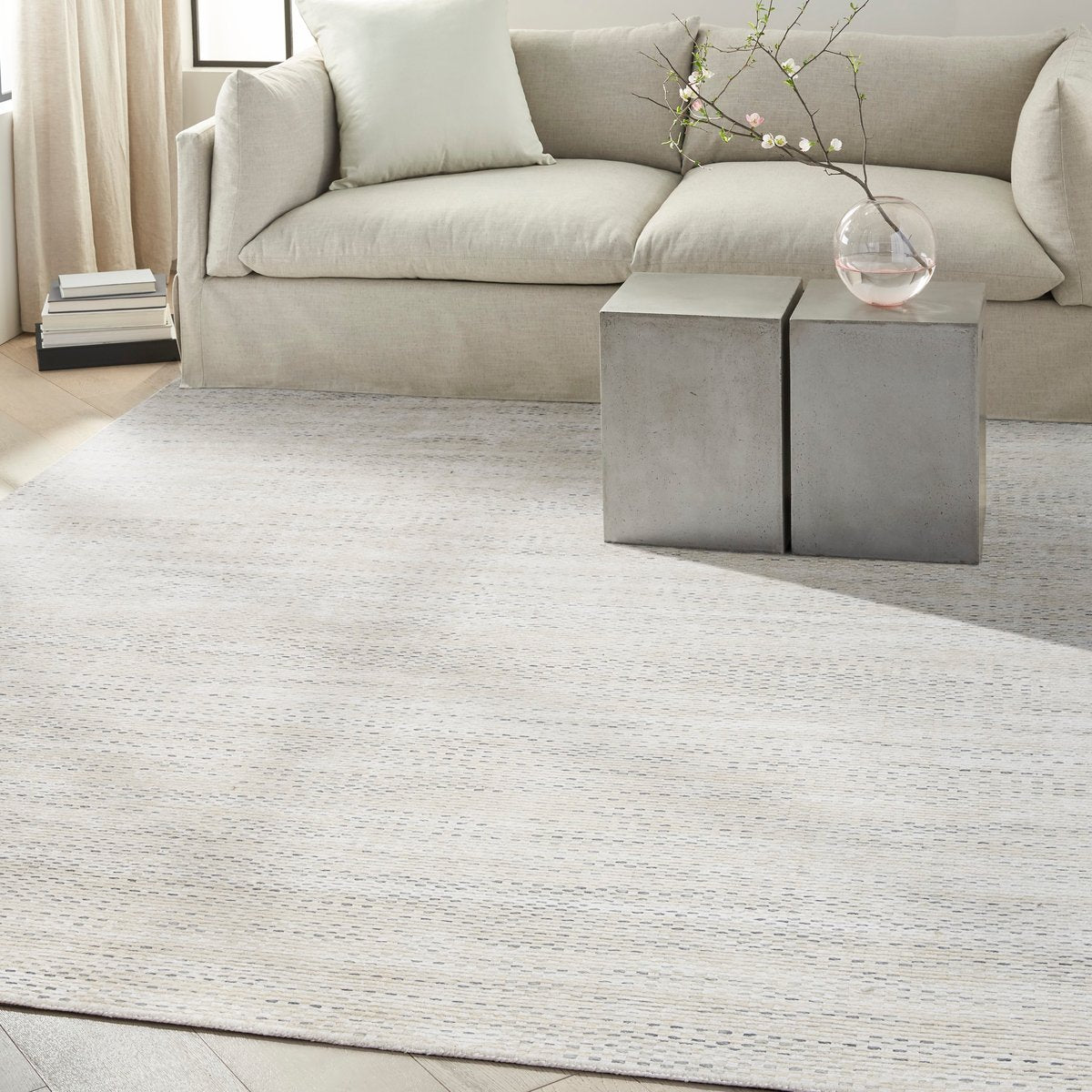 Cream textured area rug with subtle horizontal striping and natural woven pattern