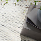 Cream textured area rug with subtle horizontal striping and natural woven pattern