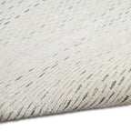 Cream textured area rug with subtle horizontal striping and natural woven pattern
