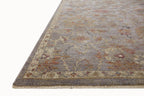 Gray traditional rug with floral pattern and ornate border in rust and gold tones