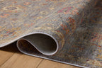Gray traditional rug with floral pattern and ornate border in rust and gold tones