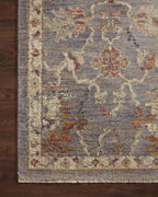 Gray traditional rug with floral pattern and ornate border in rust and gold tones