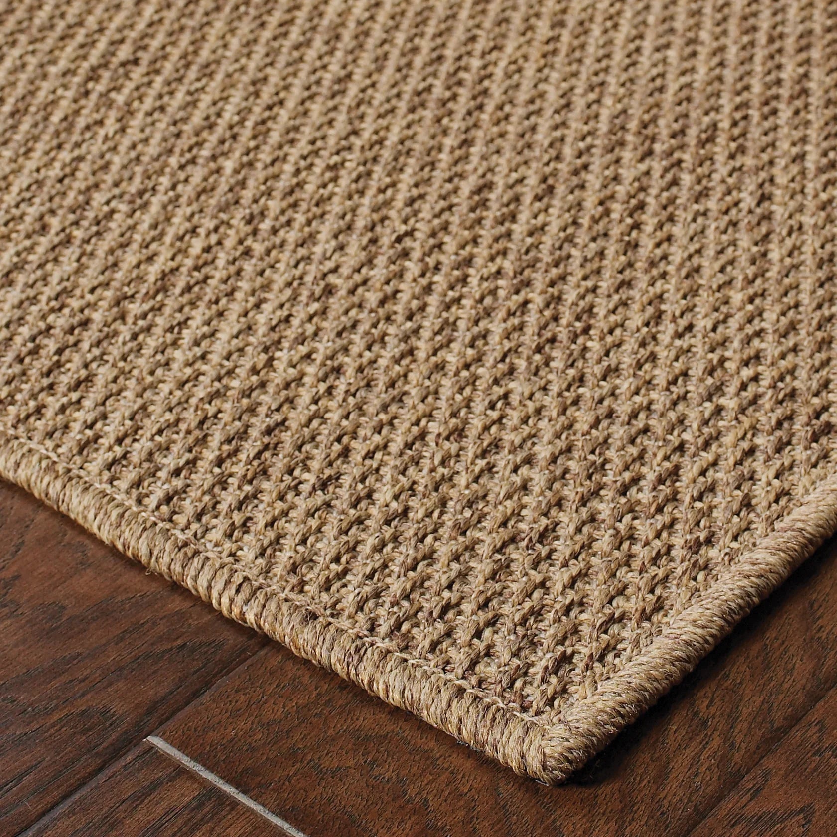 Solid tan woven area rug with natural texture and neutral color