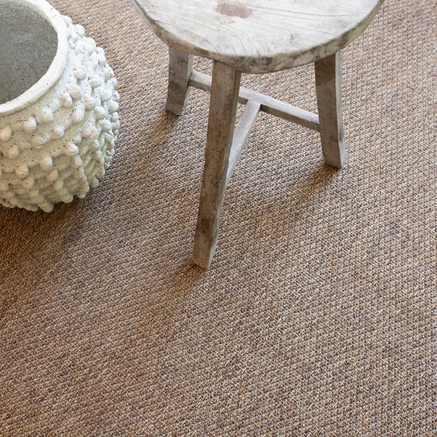 Solid tan woven area rug with natural texture and neutral color