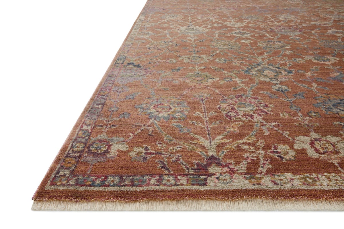 Vintage-style area rug with rust red background and ornate floral damask pattern in cream and blue tones