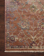 Vintage-style area rug with rust red background and ornate floral damask pattern in cream and blue tones