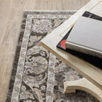 Traditional floral rug with brown center, ornate cream border and botanical pattern design