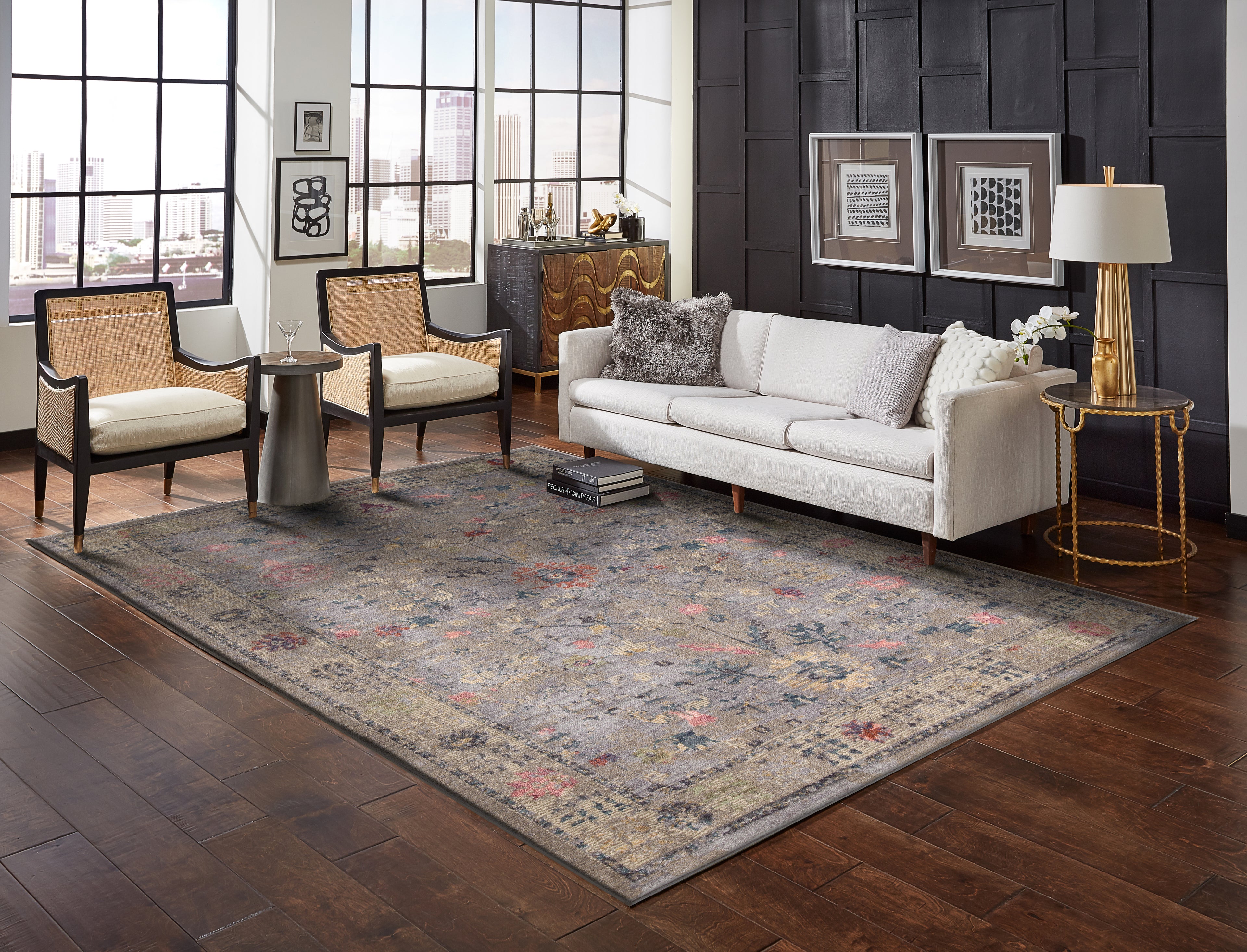 Gray traditional rug with pink floral motifs and ornate border design
